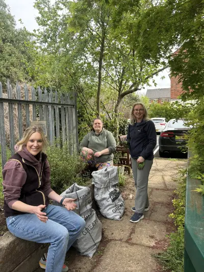 Three members of staff gardening at Sensory Matters' premises.